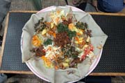 Traditional and common food - injara. Sour pankake served with variety of meet and vegertable. South, Ethiopia.