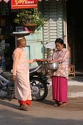 Monks are going through the village each morning. They are gathering the rice for the whole day. Nyaung U. Myanmar (Burma).