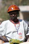 Woman at Tourou village at Mandara Mountains. Local fashion is red wooden calabashes on women' heads. They look rather like army helmets and which indicate things like their marital status. Cameroon.