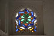 Famous 'rock palace' Dar al-Hajar at Wadi Dhahr and typical glass-colored window. Yemen.