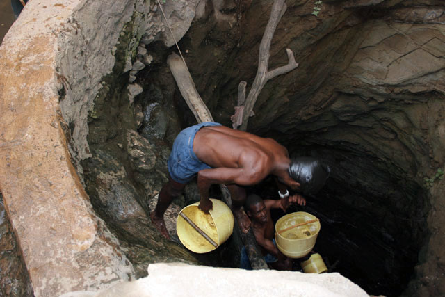 The water is retrieving from 10m deep well by men-chain to small reservoir. Men are singing for better synchronization. Singing well, Dublock. South,  Ethiopia.