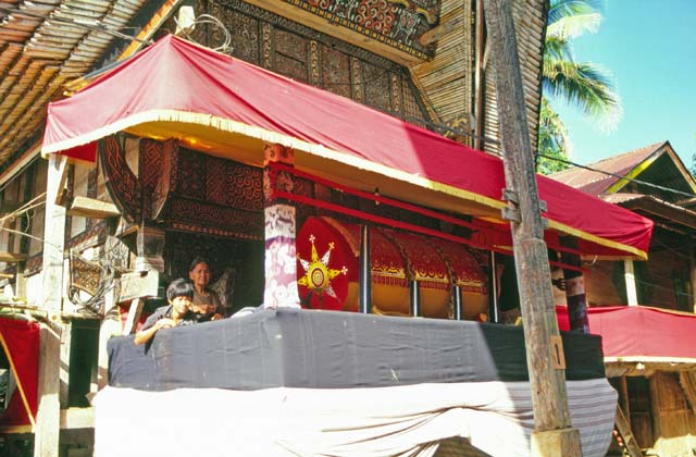 At funeral ceremony. Traditional house tongkonan with cofin. Tana Toraj area. Sulawesi,  Indonesia.