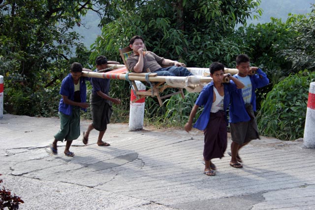 Porters are available also for people. Kyaiktiyo. Myanmar (Burma).